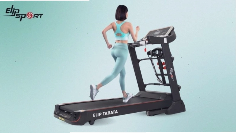 Người đàn ông tập luyện với máy ép chân trong phòng gym hiện đại