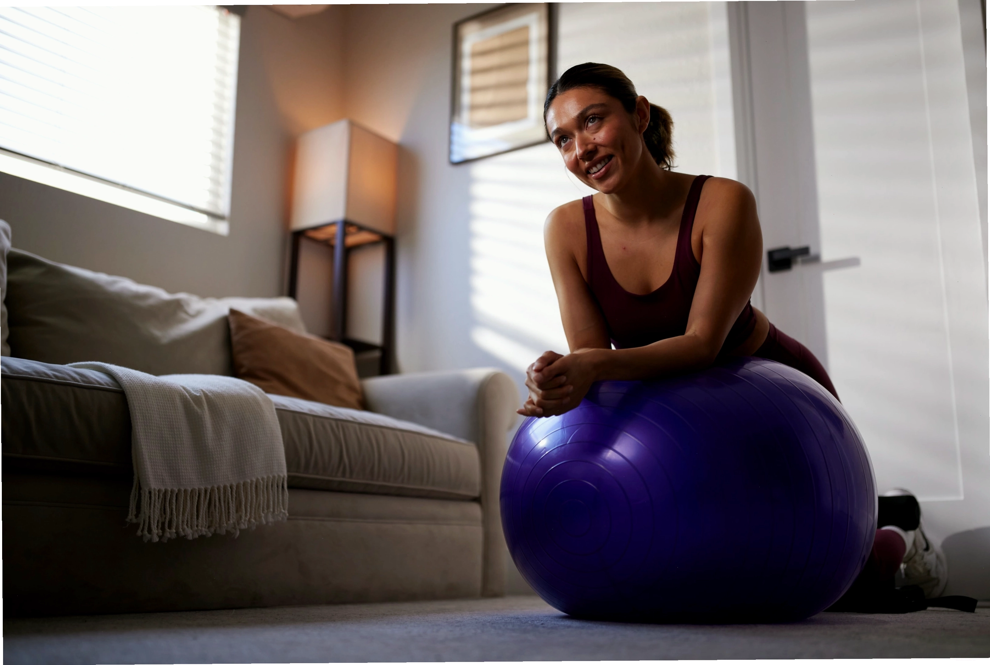 Người tập thực hiện bài tập yoga trên bóng với tư thế chuẩn bị