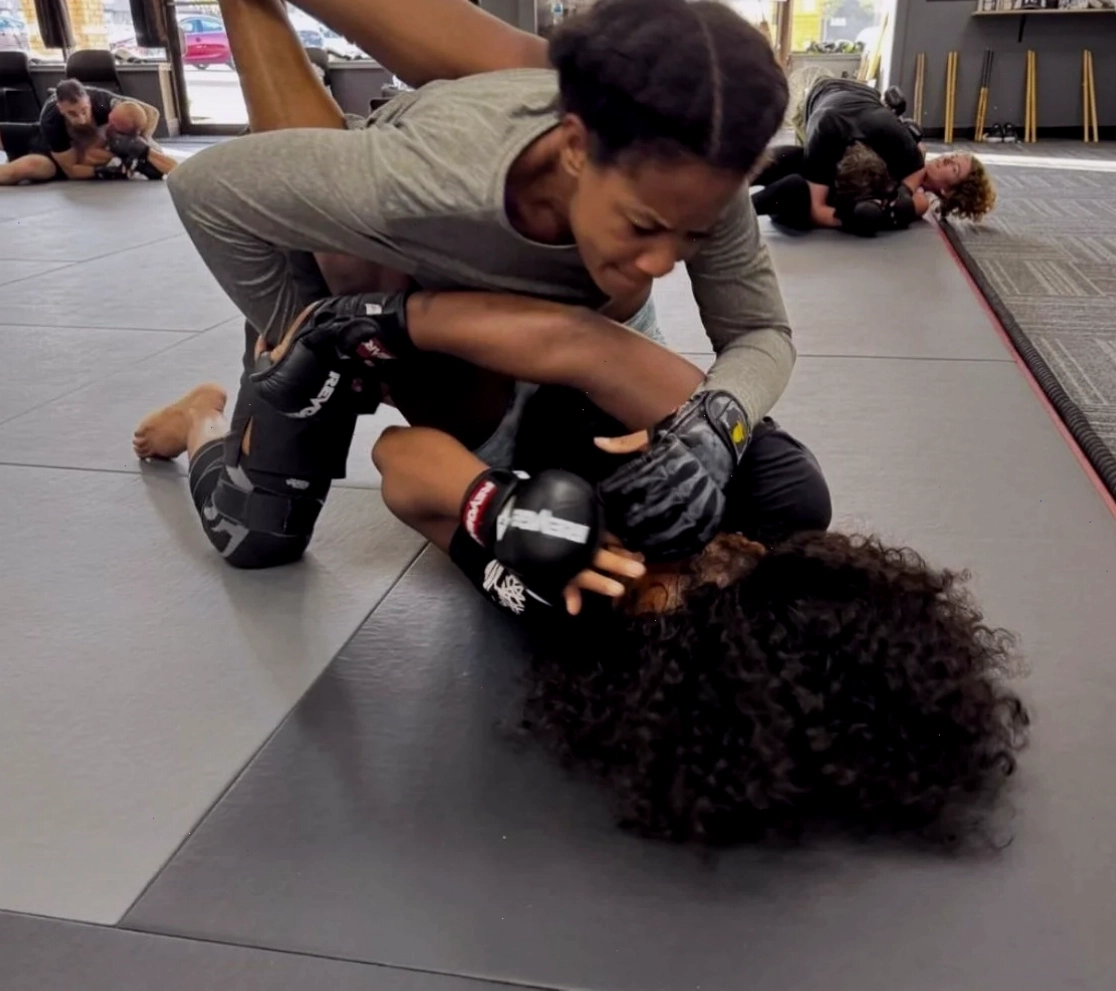 Tập luyện kỹ thuật khóa siết dưới sàn trong lớp MMA tại Fight Club Fitness